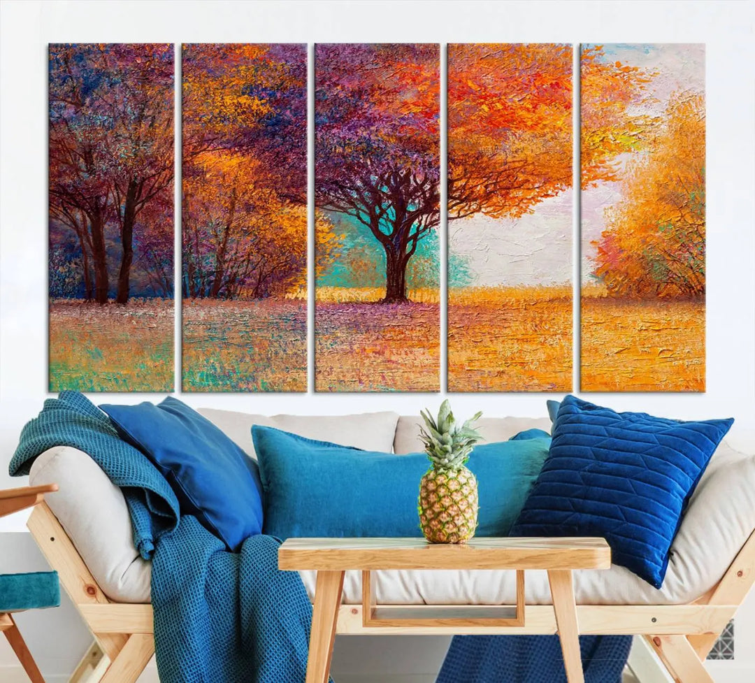 The "Colorful Tree in Autumn" wall art canvas print features a three-panel depiction of a vibrant autumn landscape, gallery wrapped on museum-quality polycotton with UV-protective coating, enhancing the wall in a stylish living room.