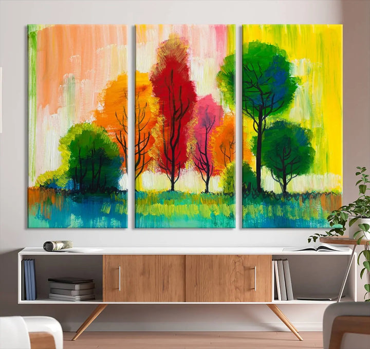 A modern living room features the "Colorful Trees Wall Art Canvas Print" on museum-quality canvases.