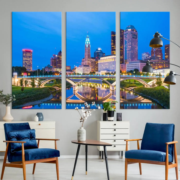 The modern living room is enhanced by the striking Columbus City Lights Bright Blue Skyline Cityscape View Wall Art Canvas Print displayed above white cabinets. This piece is crafted on museum-quality canvas with a UV-protective coating to ensure lasting beauty and vibrant colors.