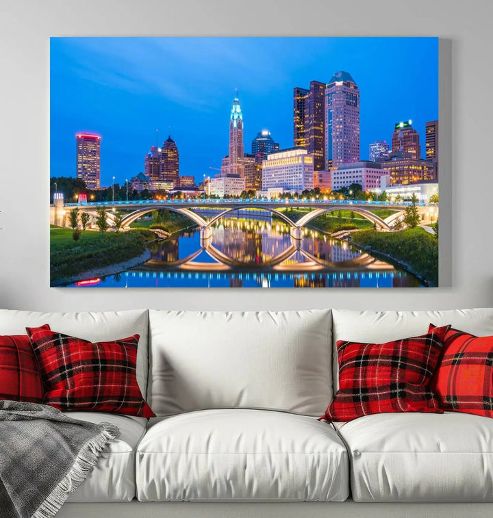 The modern living room is enhanced by the striking Columbus City Lights Bright Blue Skyline Cityscape View Wall Art Canvas Print displayed above white cabinets. This piece is crafted on museum-quality canvas with a UV-protective coating to ensure lasting beauty and vibrant colors.