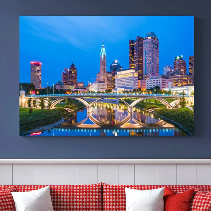 The modern living room is enhanced by the striking Columbus City Lights Bright Blue Skyline Cityscape View Wall Art Canvas Print displayed above white cabinets. This piece is crafted on museum-quality canvas with a UV-protective coating to ensure lasting beauty and vibrant colors.