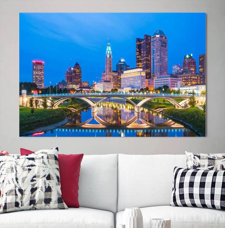 The modern living room is enhanced by the striking Columbus City Lights Bright Blue Skyline Cityscape View Wall Art Canvas Print displayed above white cabinets. This piece is crafted on museum-quality canvas with a UV-protective coating to ensure lasting beauty and vibrant colors.