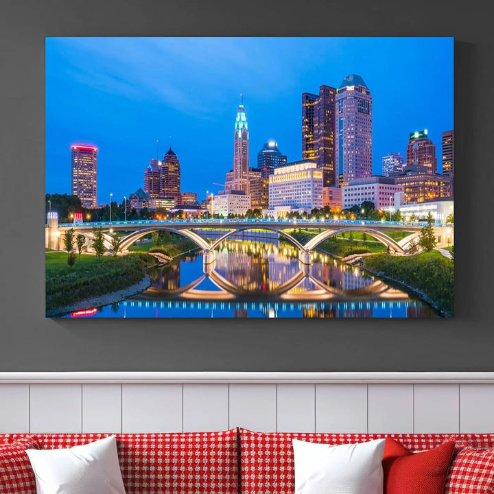 The modern living room is enhanced by the striking Columbus City Lights Bright Blue Skyline Cityscape View Wall Art Canvas Print displayed above white cabinets. This piece is crafted on museum-quality canvas with a UV-protective coating to ensure lasting beauty and vibrant colors.