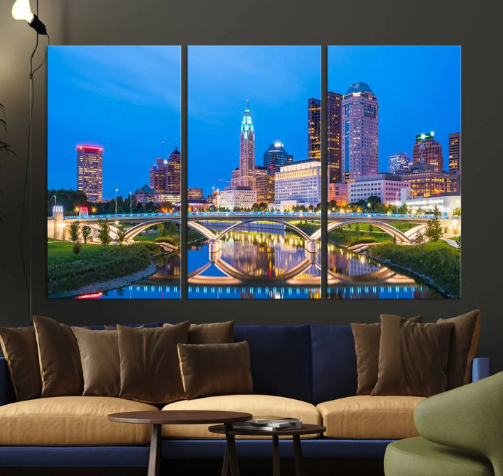 The modern living room is enhanced by the striking Columbus City Lights Bright Blue Skyline Cityscape View Wall Art Canvas Print displayed above white cabinets. This piece is crafted on museum-quality canvas with a UV-protective coating to ensure lasting beauty and vibrant colors.