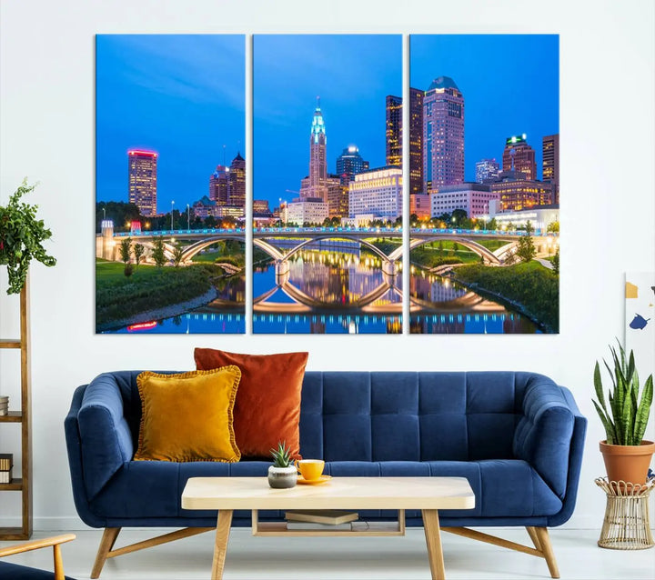 The modern living room is enhanced by the striking Columbus City Lights Bright Blue Skyline Cityscape View Wall Art Canvas Print displayed above white cabinets. This piece is crafted on museum-quality canvas with a UV-protective coating to ensure lasting beauty and vibrant colors.