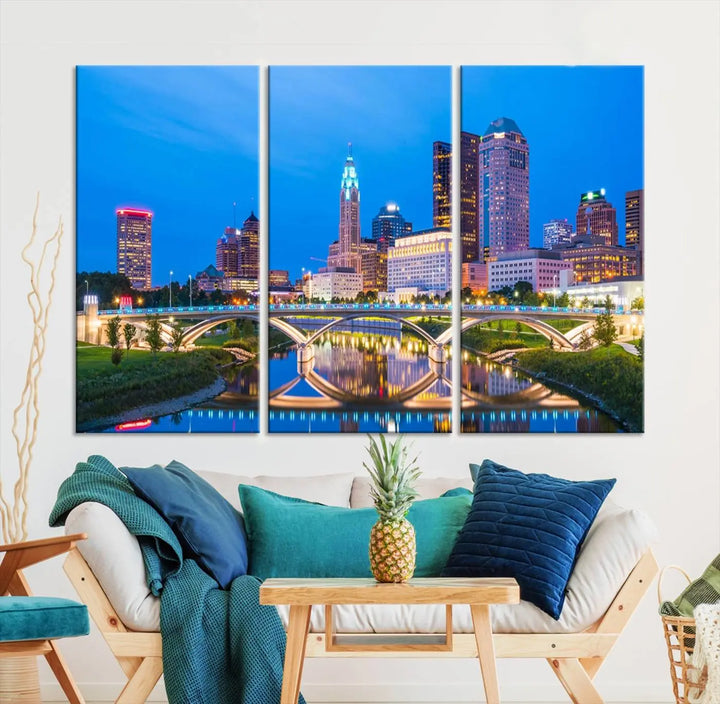 The modern living room is enhanced by the striking Columbus City Lights Bright Blue Skyline Cityscape View Wall Art Canvas Print displayed above white cabinets. This piece is crafted on museum-quality canvas with a UV-protective coating to ensure lasting beauty and vibrant colors.