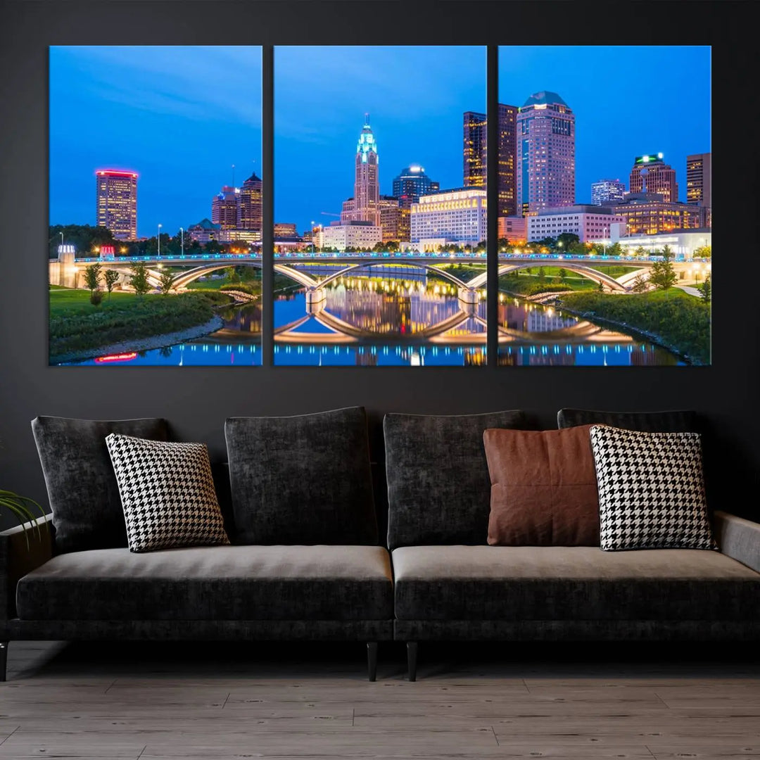 The modern living room is enhanced by the striking Columbus City Lights Bright Blue Skyline Cityscape View Wall Art Canvas Print displayed above white cabinets. This piece is crafted on museum-quality canvas with a UV-protective coating to ensure lasting beauty and vibrant colors.