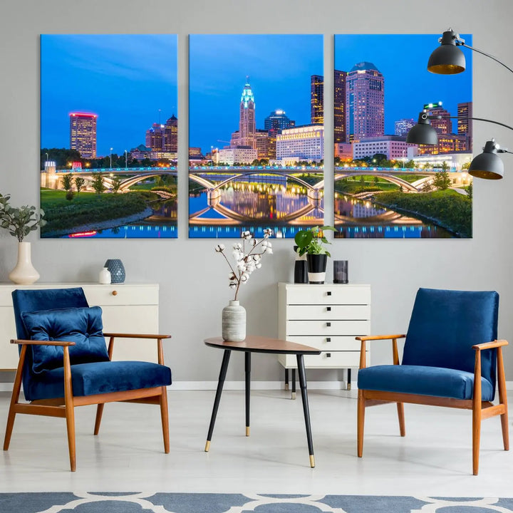 The modern living room is enhanced by the striking Columbus City Lights Bright Blue Skyline Cityscape View Wall Art Canvas Print displayed above white cabinets. This piece is crafted on museum-quality canvas with a UV-protective coating to ensure lasting beauty and vibrant colors.