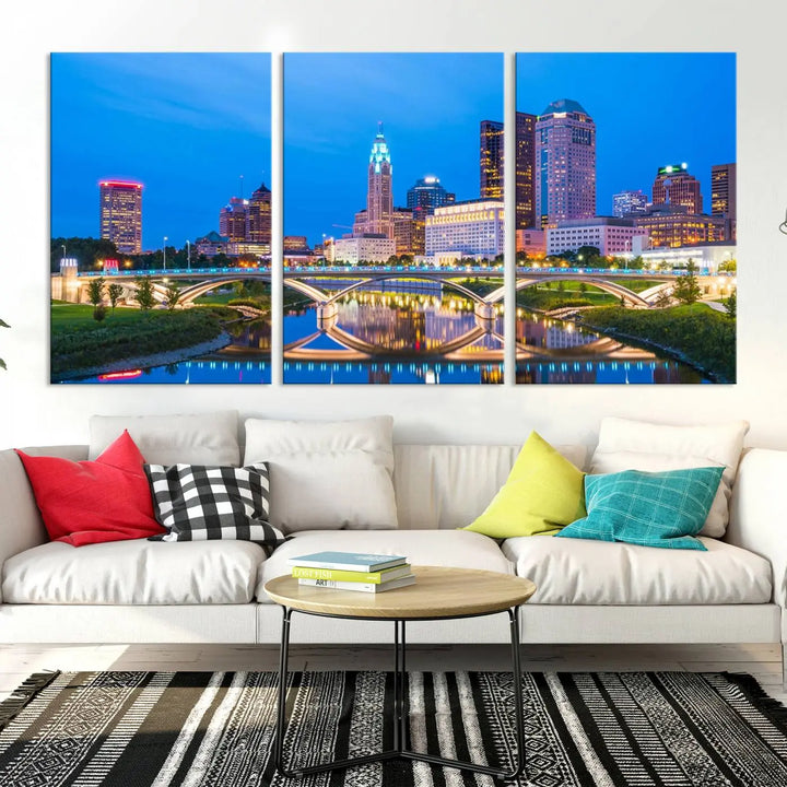 The modern living room is enhanced by the striking Columbus City Lights Bright Blue Skyline Cityscape View Wall Art Canvas Print displayed above white cabinets. This piece is crafted on museum-quality canvas with a UV-protective coating to ensure lasting beauty and vibrant colors.