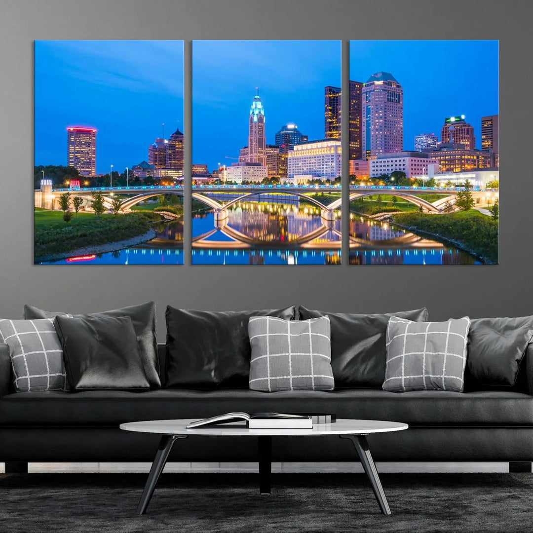 The modern living room is enhanced by the striking Columbus City Lights Bright Blue Skyline Cityscape View Wall Art Canvas Print displayed above white cabinets. This piece is crafted on museum-quality canvas with a UV-protective coating to ensure lasting beauty and vibrant colors.