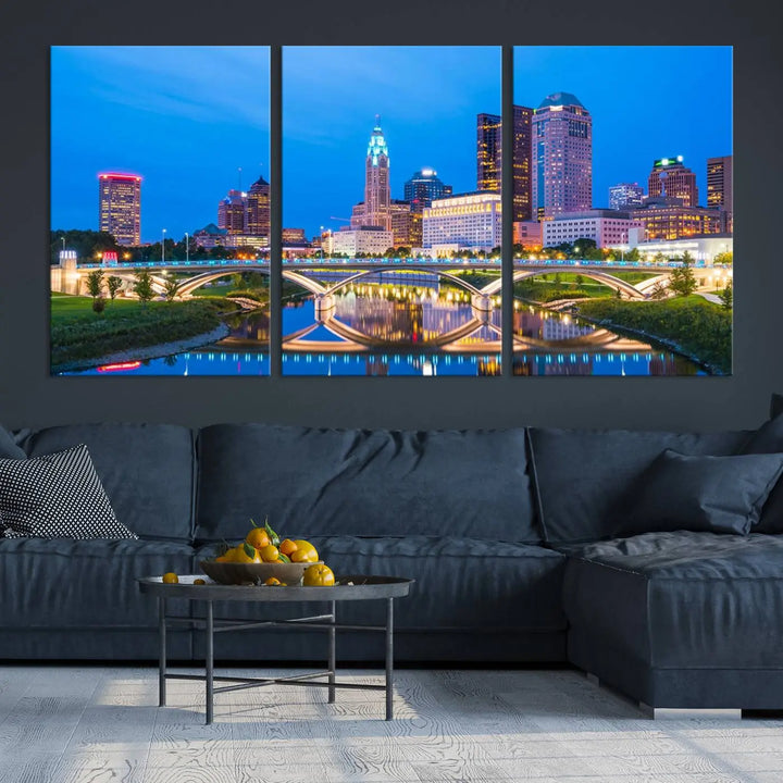 The modern living room is enhanced by the striking Columbus City Lights Bright Blue Skyline Cityscape View Wall Art Canvas Print displayed above white cabinets. This piece is crafted on museum-quality canvas with a UV-protective coating to ensure lasting beauty and vibrant colors.