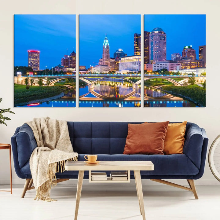 The modern living room is enhanced by the striking Columbus City Lights Bright Blue Skyline Cityscape View Wall Art Canvas Print displayed above white cabinets. This piece is crafted on museum-quality canvas with a UV-protective coating to ensure lasting beauty and vibrant colors.