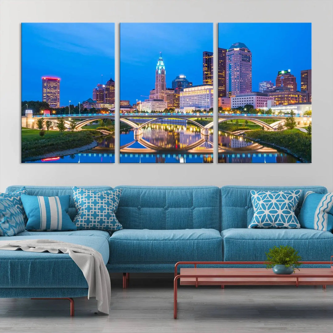 The modern living room is enhanced by the striking Columbus City Lights Bright Blue Skyline Cityscape View Wall Art Canvas Print displayed above white cabinets. This piece is crafted on museum-quality canvas with a UV-protective coating to ensure lasting beauty and vibrant colors.