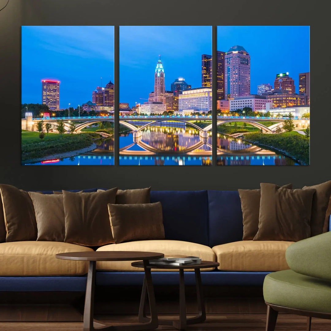 The modern living room is enhanced by the striking Columbus City Lights Bright Blue Skyline Cityscape View Wall Art Canvas Print displayed above white cabinets. This piece is crafted on museum-quality canvas with a UV-protective coating to ensure lasting beauty and vibrant colors.