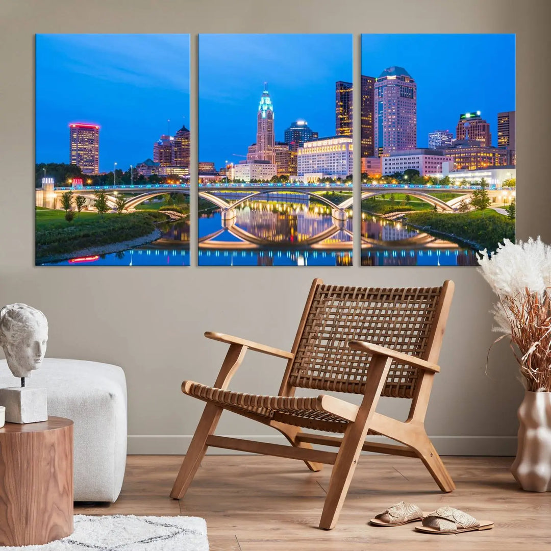 The modern living room is enhanced by the striking Columbus City Lights Bright Blue Skyline Cityscape View Wall Art Canvas Print displayed above white cabinets. This piece is crafted on museum-quality canvas with a UV-protective coating to ensure lasting beauty and vibrant colors.