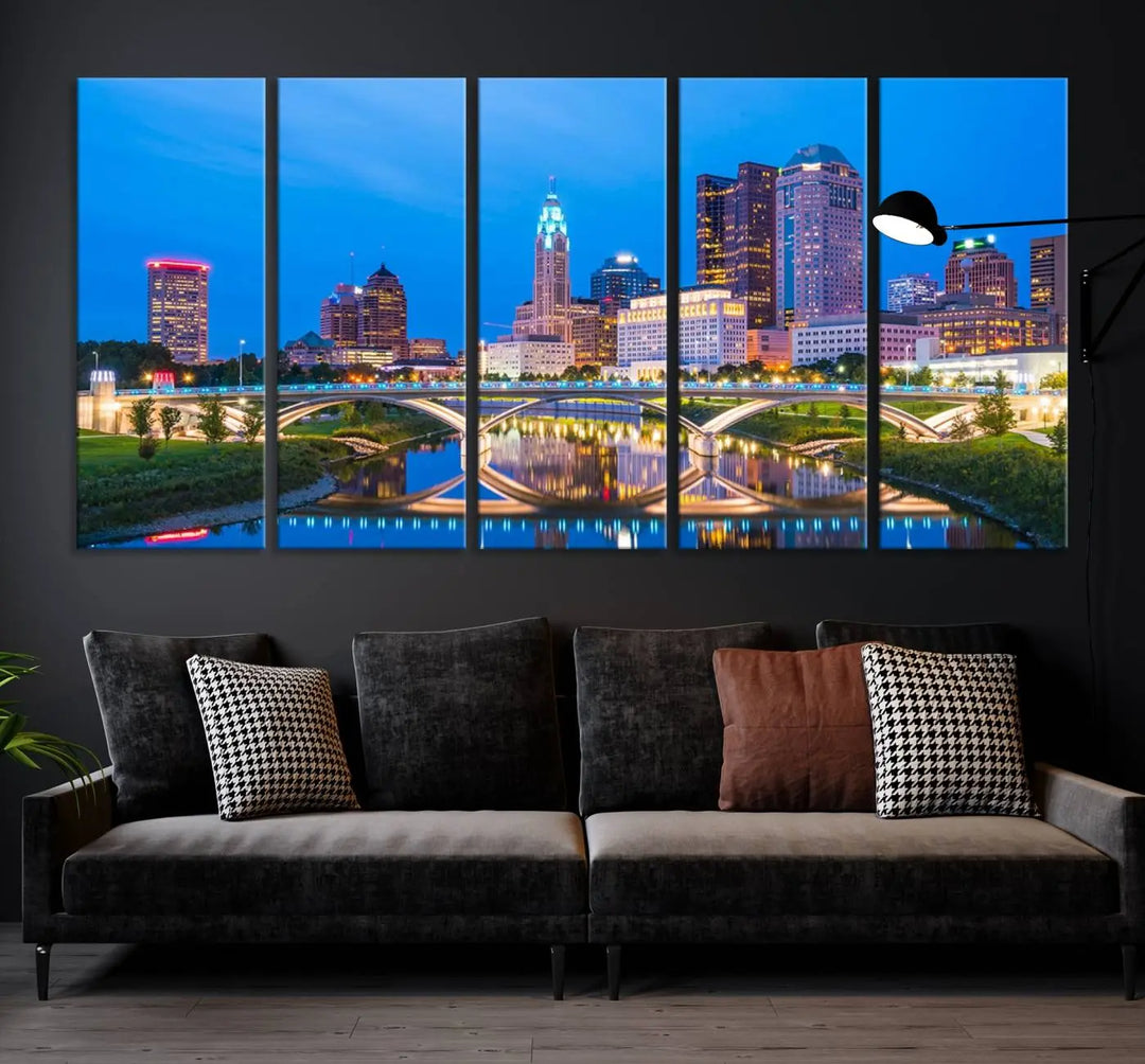 The modern living room is enhanced by the striking Columbus City Lights Bright Blue Skyline Cityscape View Wall Art Canvas Print displayed above white cabinets. This piece is crafted on museum-quality canvas with a UV-protective coating to ensure lasting beauty and vibrant colors.