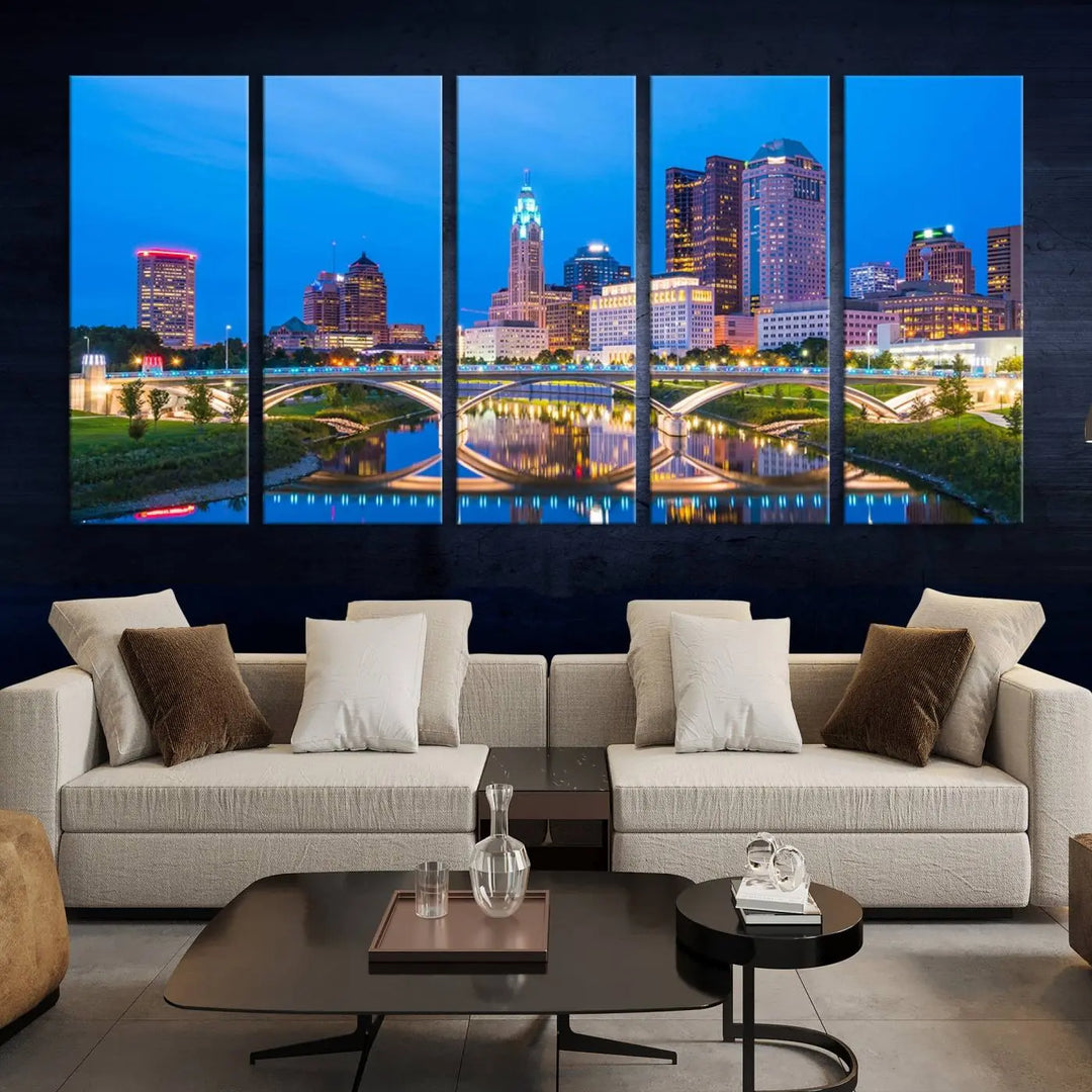 The modern living room is enhanced by the striking Columbus City Lights Bright Blue Skyline Cityscape View Wall Art Canvas Print displayed above white cabinets. This piece is crafted on museum-quality canvas with a UV-protective coating to ensure lasting beauty and vibrant colors.