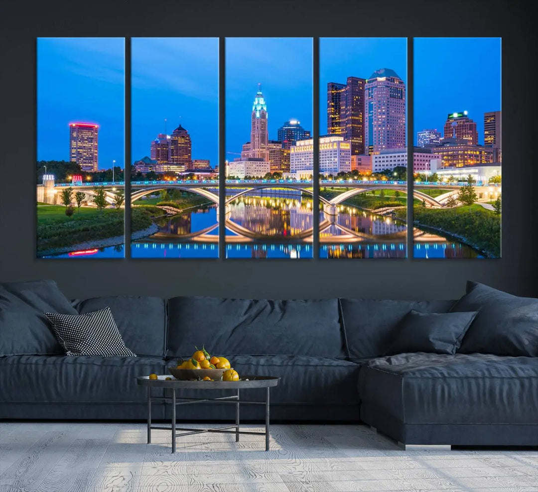 The modern living room is enhanced by the striking Columbus City Lights Bright Blue Skyline Cityscape View Wall Art Canvas Print displayed above white cabinets. This piece is crafted on museum-quality canvas with a UV-protective coating to ensure lasting beauty and vibrant colors.