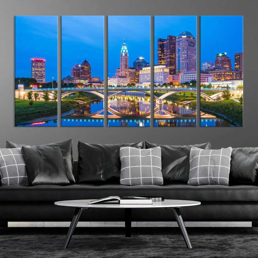 The modern living room is enhanced by the striking Columbus City Lights Bright Blue Skyline Cityscape View Wall Art Canvas Print displayed above white cabinets. This piece is crafted on museum-quality canvas with a UV-protective coating to ensure lasting beauty and vibrant colors.