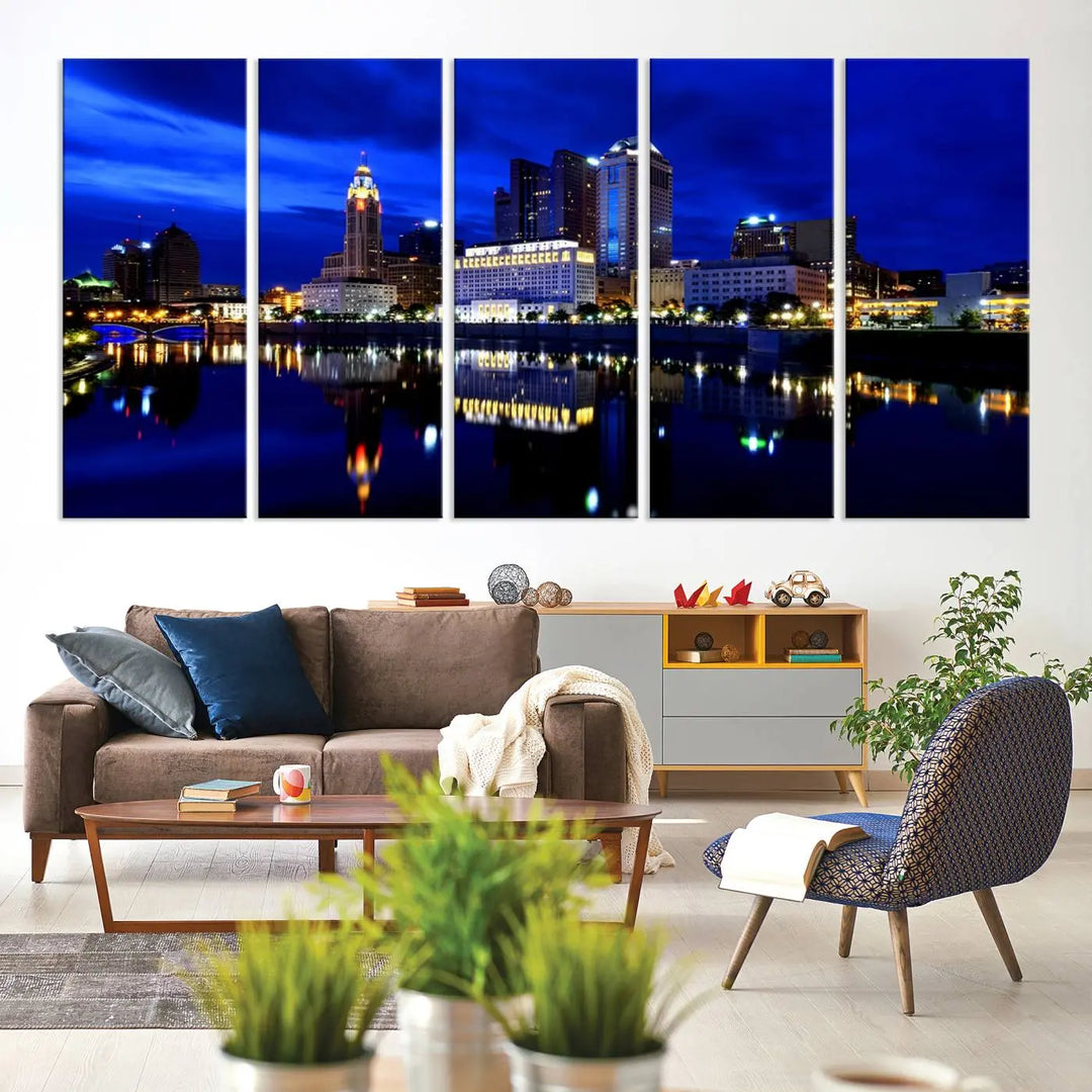 The living room showcases the Columbus City Lights Night Bright Blue Skyline Cityscape View Wall Art Canvas Print on a museum-quality canvas. The professionally hand-assembled artwork adds elegance while ensuring durable beauty.