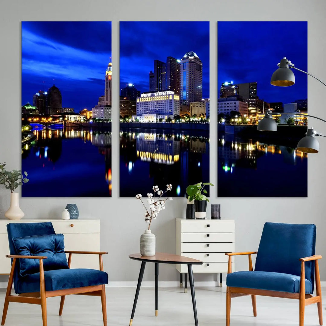 The living room showcases the Columbus City Lights Night Bright Blue Skyline Cityscape View Wall Art Canvas Print on a museum-quality canvas. The professionally hand-assembled artwork adds elegance while ensuring durable beauty.