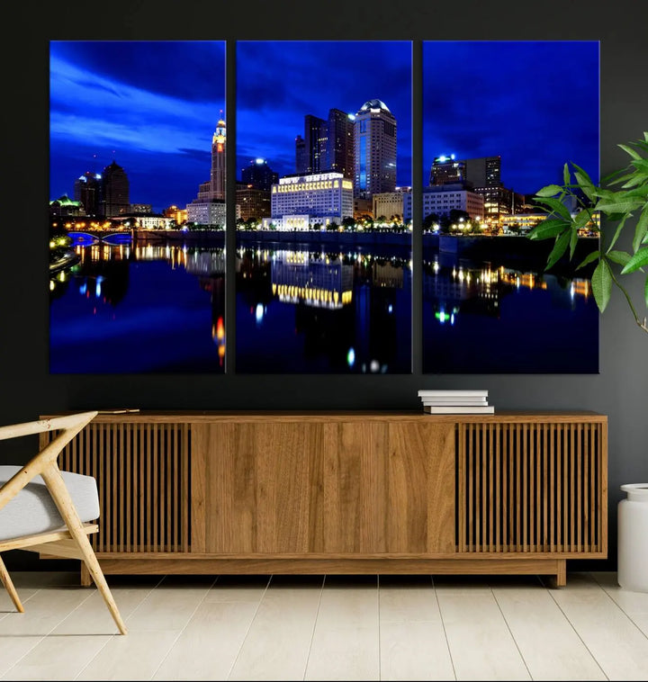 The living room showcases the Columbus City Lights Night Bright Blue Skyline Cityscape View Wall Art Canvas Print on a museum-quality canvas. The professionally hand-assembled artwork adds elegance while ensuring durable beauty.