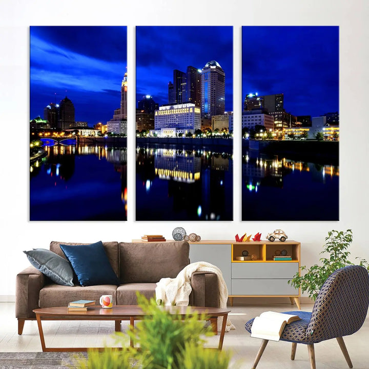 The living room showcases the Columbus City Lights Night Bright Blue Skyline Cityscape View Wall Art Canvas Print on a museum-quality canvas. The professionally hand-assembled artwork adds elegance while ensuring durable beauty.