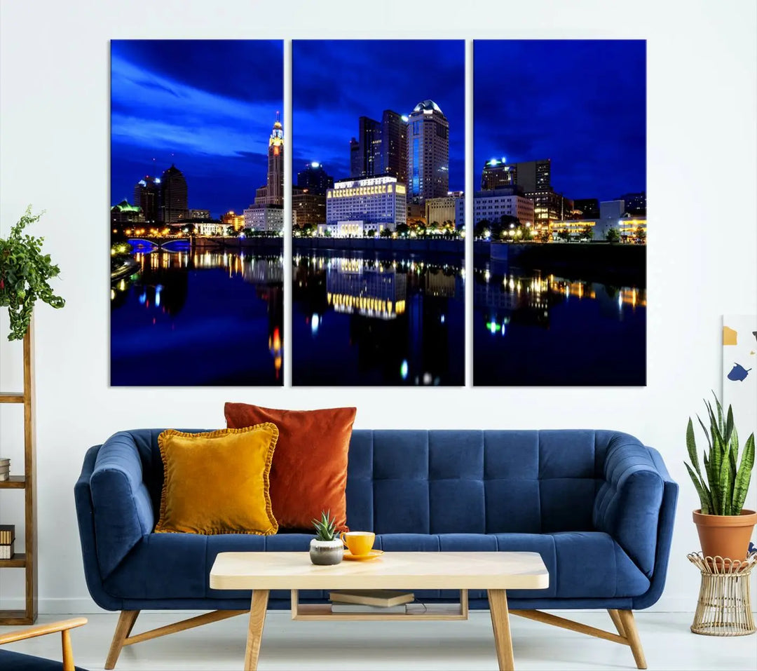 The living room showcases the Columbus City Lights Night Bright Blue Skyline Cityscape View Wall Art Canvas Print on a museum-quality canvas. The professionally hand-assembled artwork adds elegance while ensuring durable beauty.