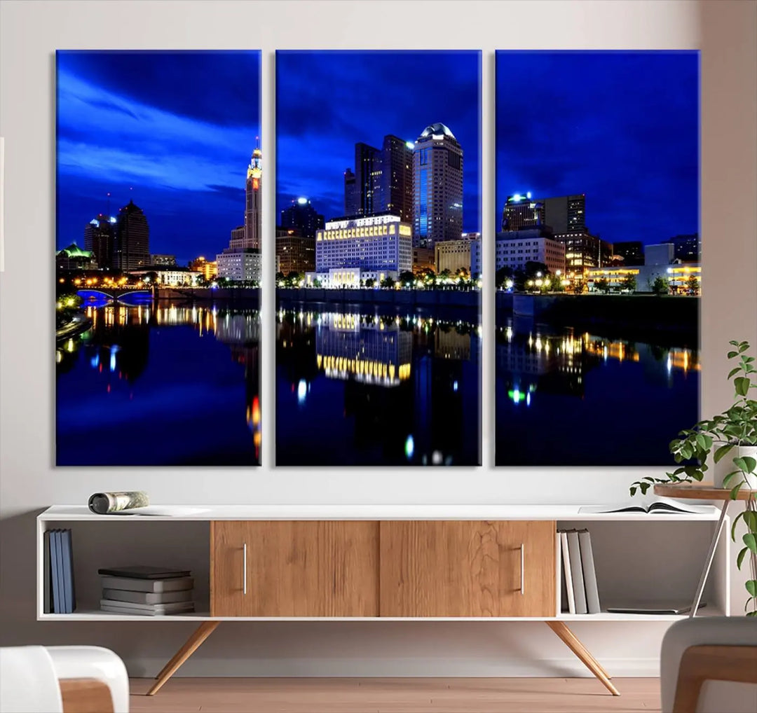 The living room showcases the Columbus City Lights Night Bright Blue Skyline Cityscape View Wall Art Canvas Print on a museum-quality canvas. The professionally hand-assembled artwork adds elegance while ensuring durable beauty.