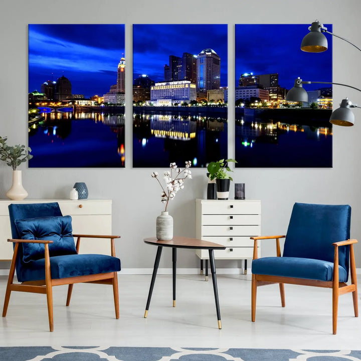 The living room showcases the Columbus City Lights Night Bright Blue Skyline Cityscape View Wall Art Canvas Print on a museum-quality canvas. The professionally hand-assembled artwork adds elegance while ensuring durable beauty.