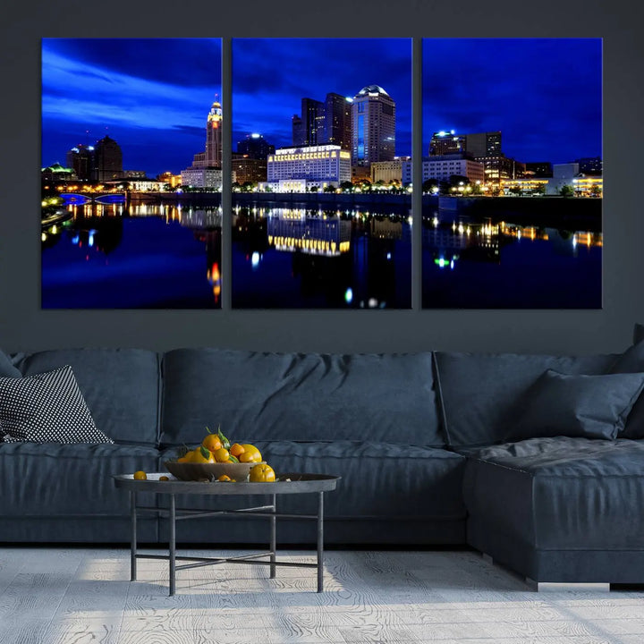 The living room showcases the Columbus City Lights Night Bright Blue Skyline Cityscape View Wall Art Canvas Print on a museum-quality canvas. The professionally hand-assembled artwork adds elegance while ensuring durable beauty.