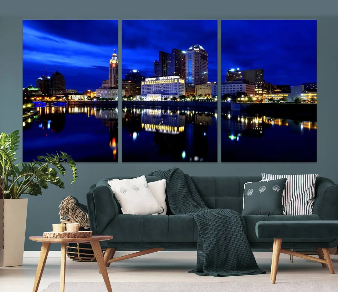 The living room showcases the Columbus City Lights Night Bright Blue Skyline Cityscape View Wall Art Canvas Print on a museum-quality canvas. The professionally hand-assembled artwork adds elegance while ensuring durable beauty.