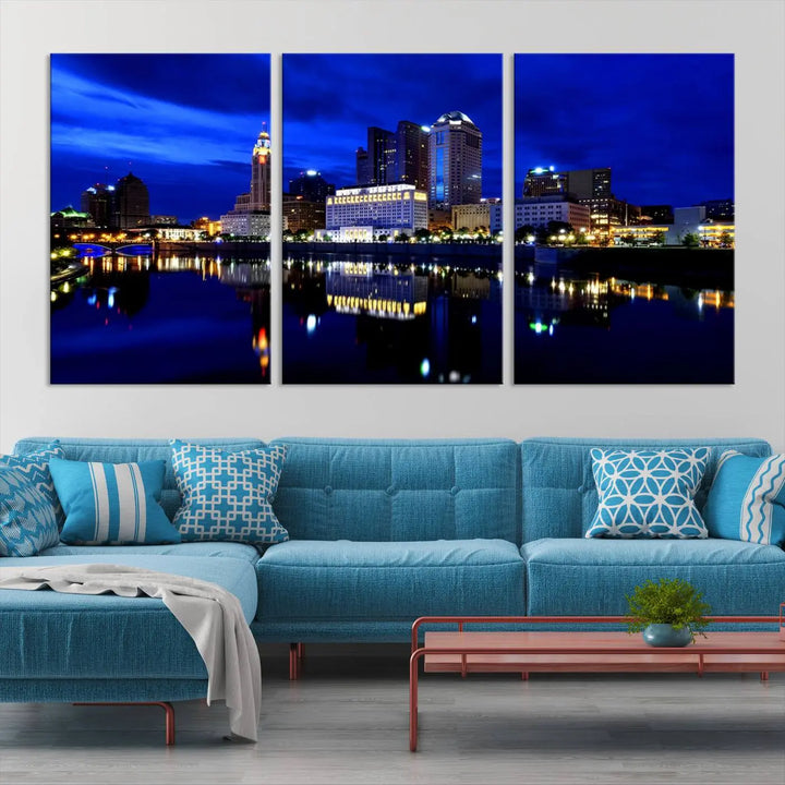 The living room showcases the Columbus City Lights Night Bright Blue Skyline Cityscape View Wall Art Canvas Print on a museum-quality canvas. The professionally hand-assembled artwork adds elegance while ensuring durable beauty.