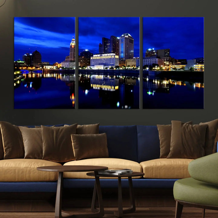 The living room showcases the Columbus City Lights Night Bright Blue Skyline Cityscape View Wall Art Canvas Print on a museum-quality canvas. The professionally hand-assembled artwork adds elegance while ensuring durable beauty.