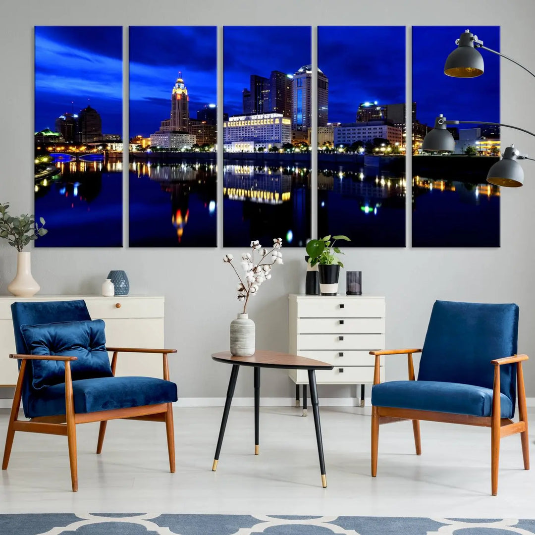 The living room showcases the Columbus City Lights Night Bright Blue Skyline Cityscape View Wall Art Canvas Print on a museum-quality canvas. The professionally hand-assembled artwork adds elegance while ensuring durable beauty.