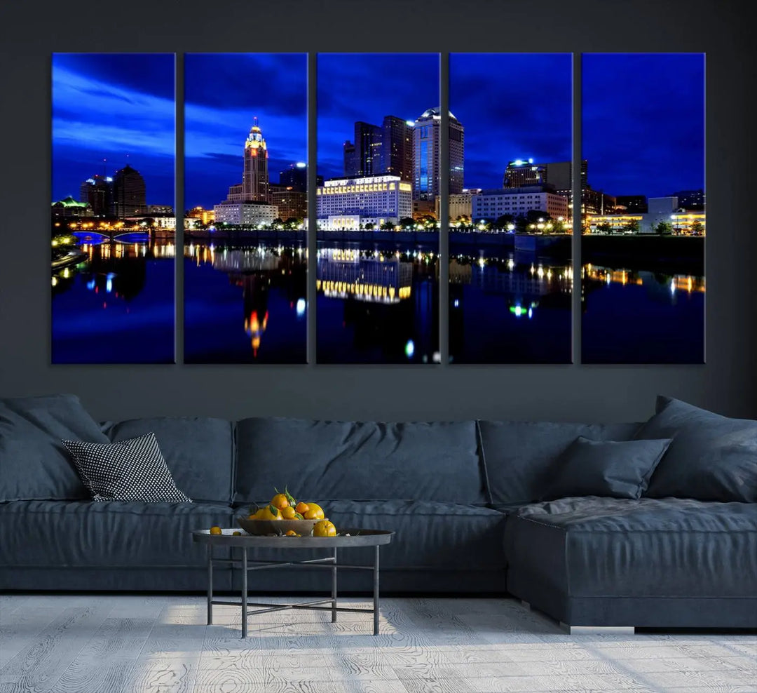 The living room showcases the Columbus City Lights Night Bright Blue Skyline Cityscape View Wall Art Canvas Print on a museum-quality canvas. The professionally hand-assembled artwork adds elegance while ensuring durable beauty.