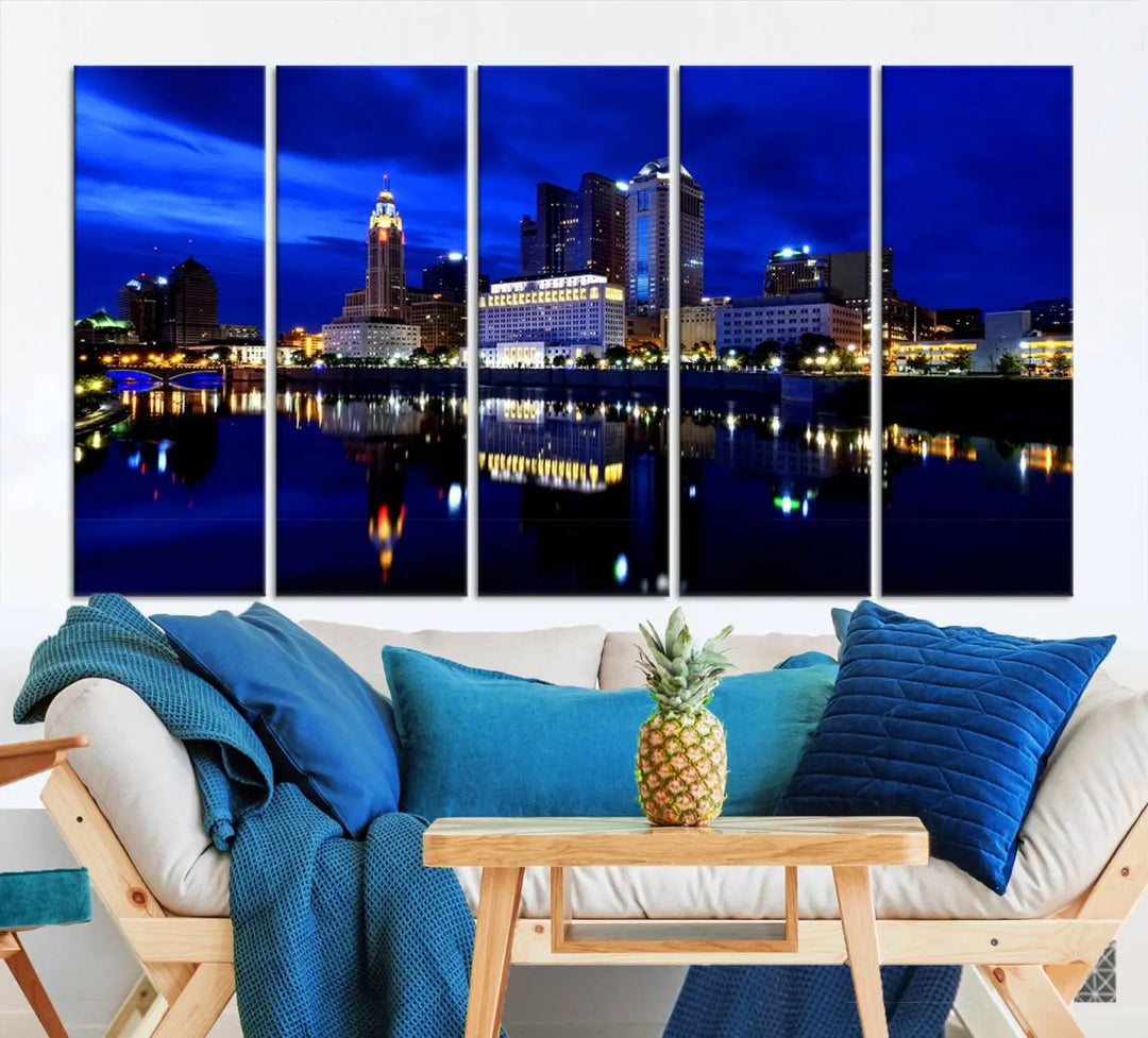 The living room showcases the Columbus City Lights Night Bright Blue Skyline Cityscape View Wall Art Canvas Print on a museum-quality canvas. The professionally hand-assembled artwork adds elegance while ensuring durable beauty.