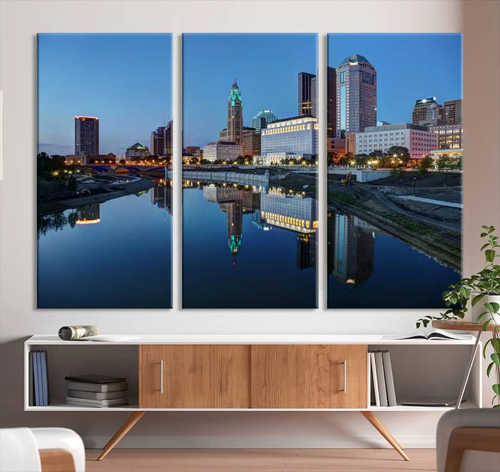 Enhance your modern dining area with the "Columbus City Lights Night Skyline Cityscape View Wall Art Canvas Print," capturing an urban scene of a cityscape mirrored on a tranquil river at dusk. This museum-quality canvas includes a UV-protective coating, guaranteeing its long-lasting brilliance. Enjoy free shipping while adding this piece of urban tranquility to your home.