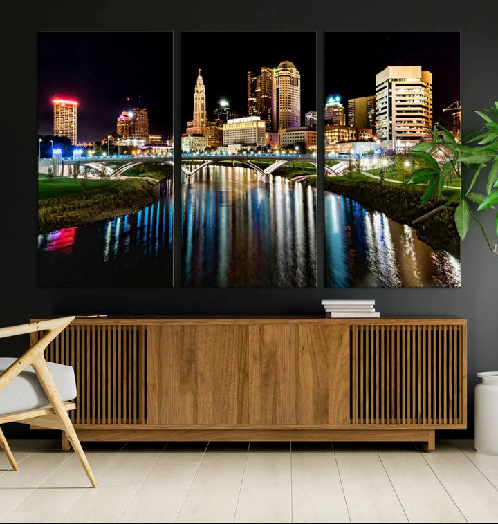 A triptych of the Columbus City Lights Night Skyline Cityscape View Wall Art Canvas Print is displayed, serving as a striking focal point in the room.