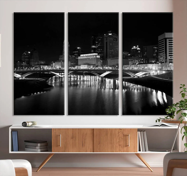 The living room features the "Columbus City Lights Skyline Black and White Wall Art Cityscape Canvas Print" above a coffee table. This artwork is presented as a triptych on museum-quality canvases with UV-protective coating.