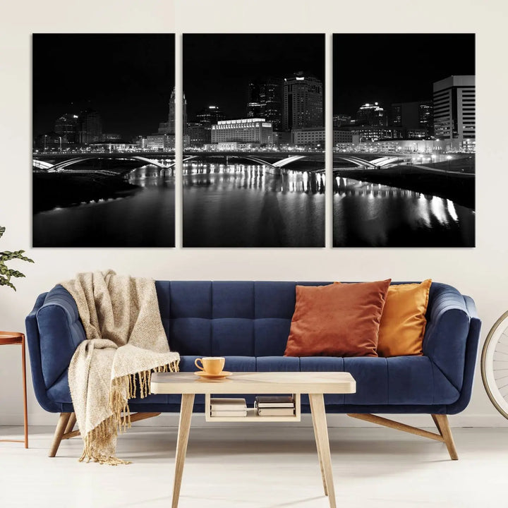 The living room features the "Columbus City Lights Skyline Black and White Wall Art Cityscape Canvas Print" above a coffee table. This artwork is presented as a triptych on museum-quality canvases with UV-protective coating.