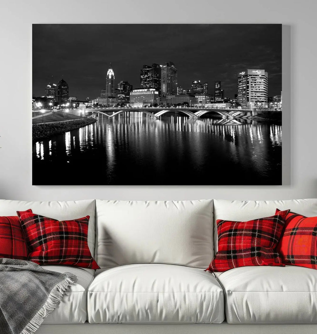 In a modern living room, the Columbus City Lights Skyline Black and White Wall Art cityscape canvas print elegantly adorns the wall above the couch. Its UV-protective coating ensures lasting elegance, and you can enjoy free shipping on this stylish centerpiece.