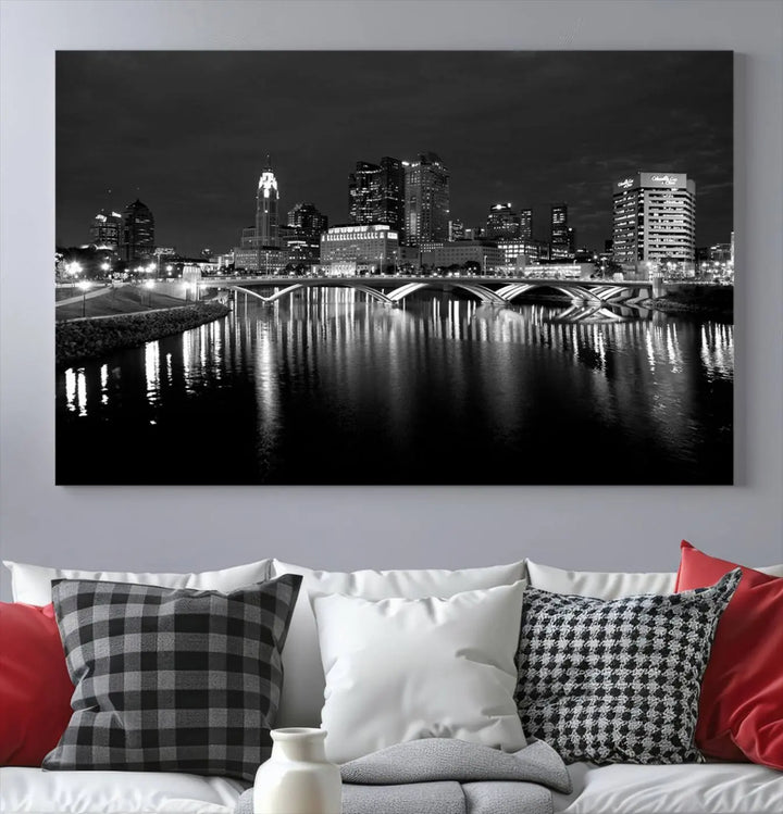 In a modern living room, the Columbus City Lights Skyline Black and White Wall Art cityscape canvas print elegantly adorns the wall above the couch. Its UV-protective coating ensures lasting elegance, and you can enjoy free shipping on this stylish centerpiece.