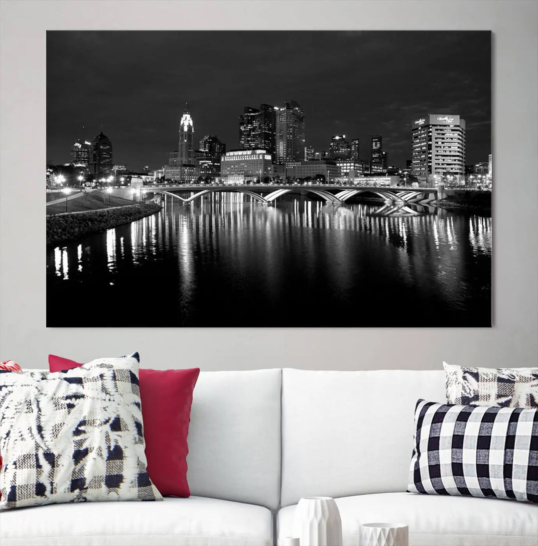 In a modern living room, the Columbus City Lights Skyline Black and White Wall Art cityscape canvas print elegantly adorns the wall above the couch. Its UV-protective coating ensures lasting elegance, and you can enjoy free shipping on this stylish centerpiece.