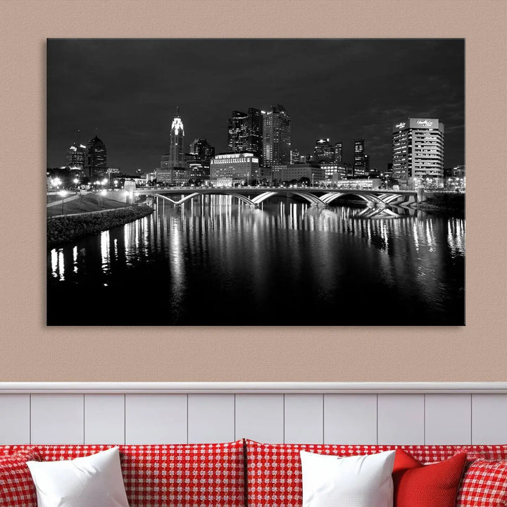 In a modern living room, the Columbus City Lights Skyline Black and White Wall Art cityscape canvas print elegantly adorns the wall above the couch. Its UV-protective coating ensures lasting elegance, and you can enjoy free shipping on this stylish centerpiece.