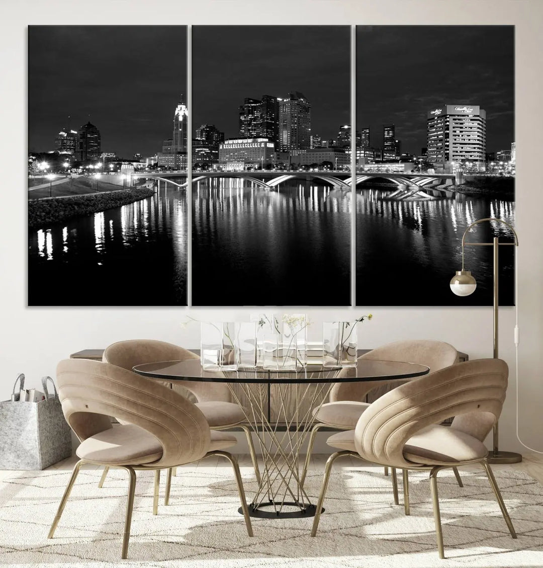 In a modern living room, the Columbus City Lights Skyline Black and White Wall Art cityscape canvas print elegantly adorns the wall above the couch. Its UV-protective coating ensures lasting elegance, and you can enjoy free shipping on this stylish centerpiece.