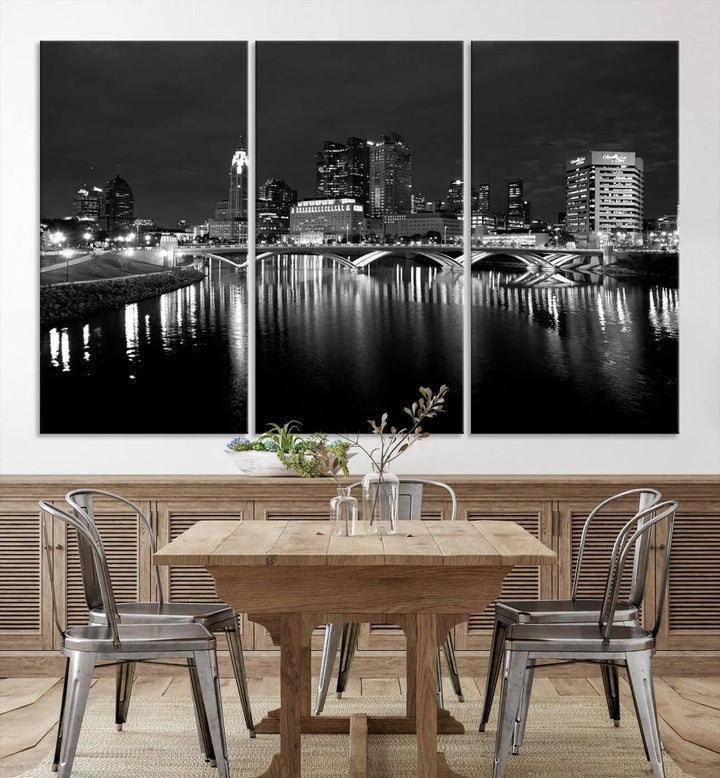 In a modern living room, the Columbus City Lights Skyline Black and White Wall Art cityscape canvas print elegantly adorns the wall above the couch. Its UV-protective coating ensures lasting elegance, and you can enjoy free shipping on this stylish centerpiece.