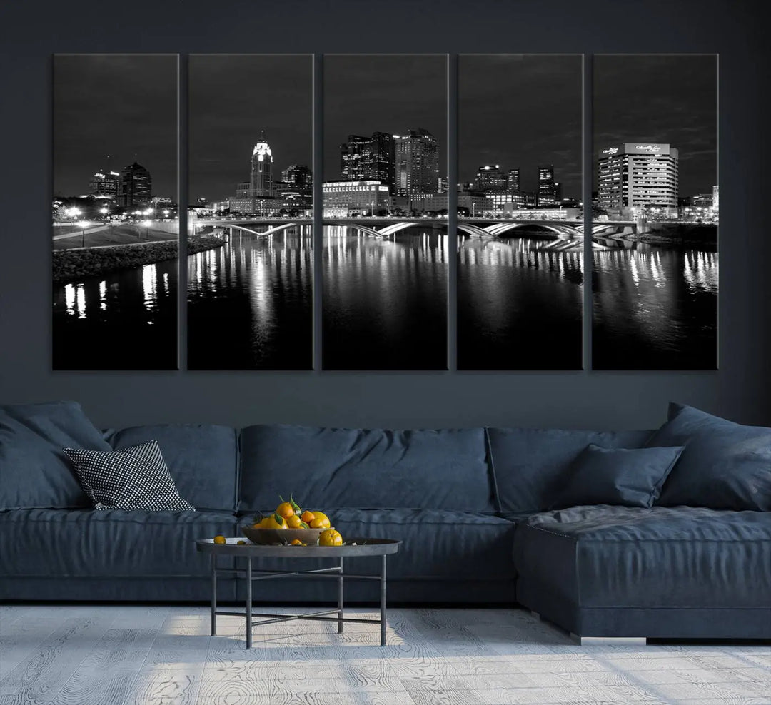 In a modern living room, the Columbus City Lights Skyline Black and White Wall Art cityscape canvas print elegantly adorns the wall above the couch. Its UV-protective coating ensures lasting elegance, and you can enjoy free shipping on this stylish centerpiece.