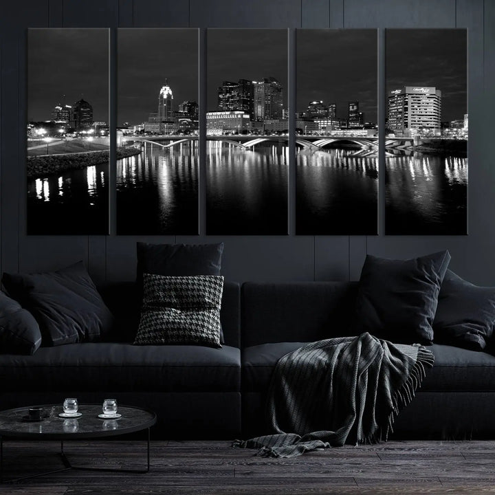 In a modern living room, the Columbus City Lights Skyline Black and White Wall Art cityscape canvas print elegantly adorns the wall above the couch. Its UV-protective coating ensures lasting elegance, and you can enjoy free shipping on this stylish centerpiece.