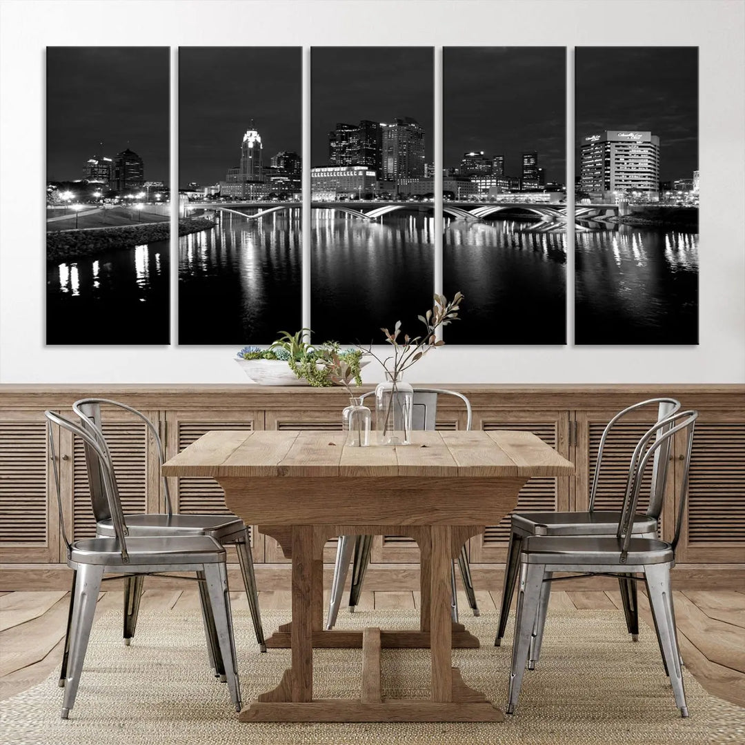 In a modern living room, the Columbus City Lights Skyline Black and White Wall Art cityscape canvas print elegantly adorns the wall above the couch. Its UV-protective coating ensures lasting elegance, and you can enjoy free shipping on this stylish centerpiece.